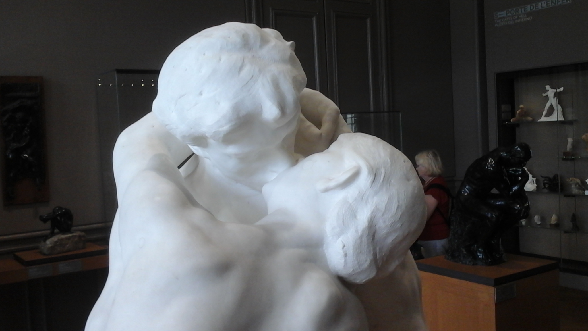 A close-up of a marble sculpture of two people kissing