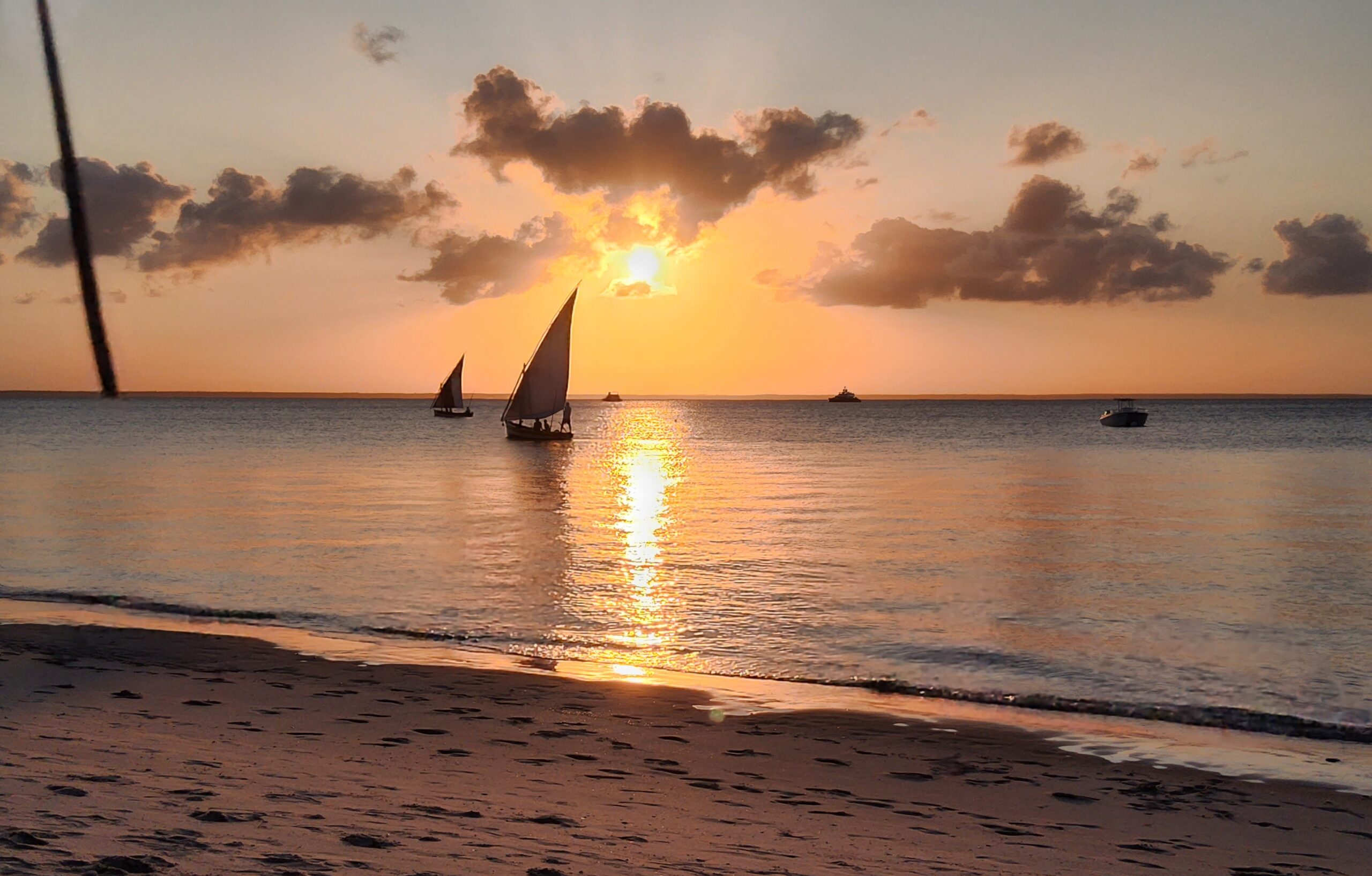 Sailing boats at sunset, taken from a beach