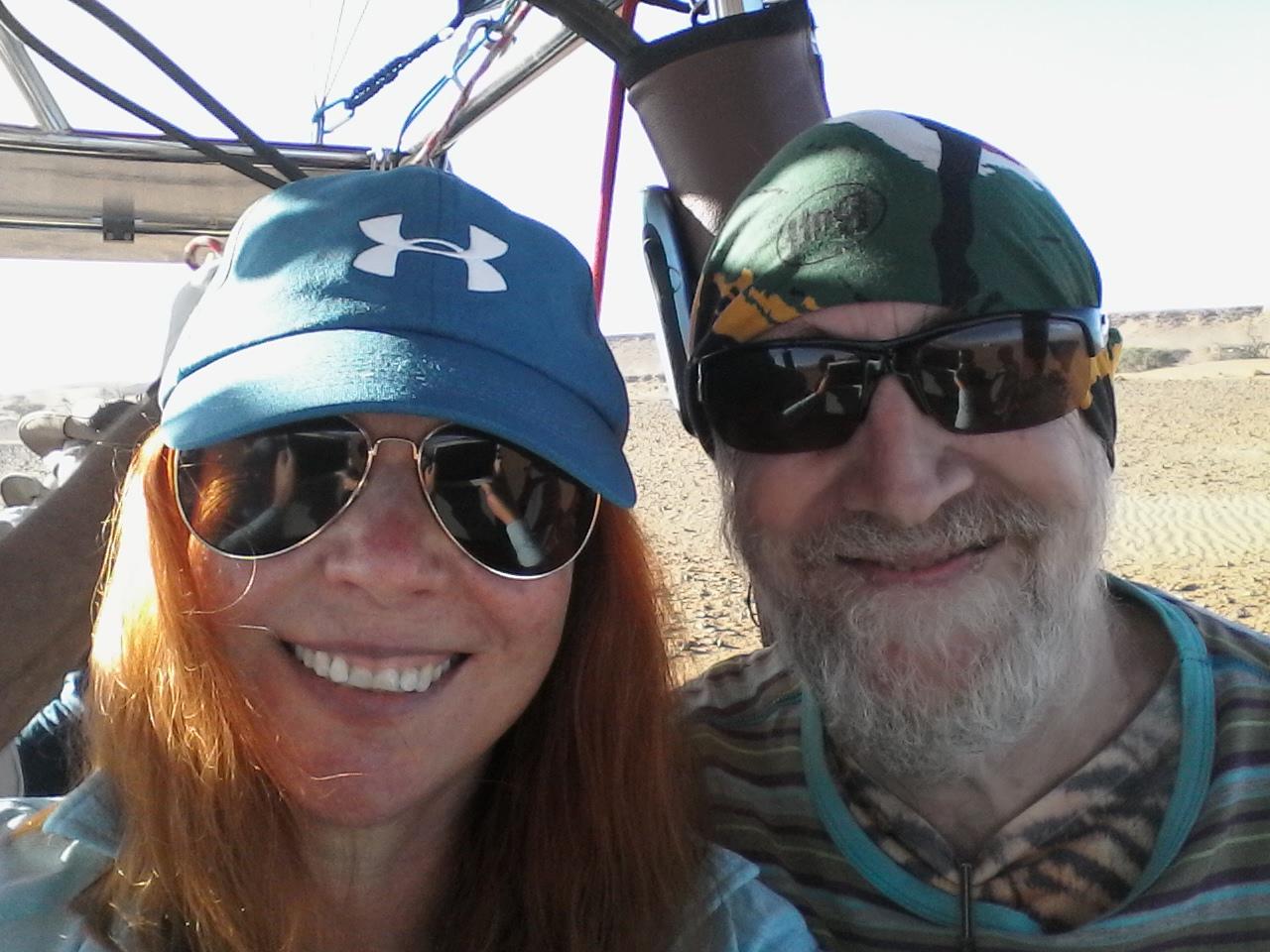 Close-up of a happy and excited couple wearing reflective sunglasses